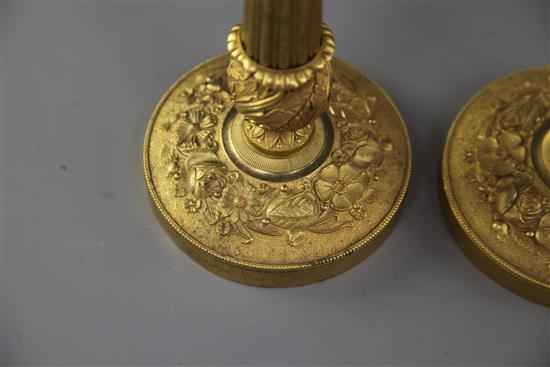 A pair of French Empire style ormolu candlesticks, height 12.25in.